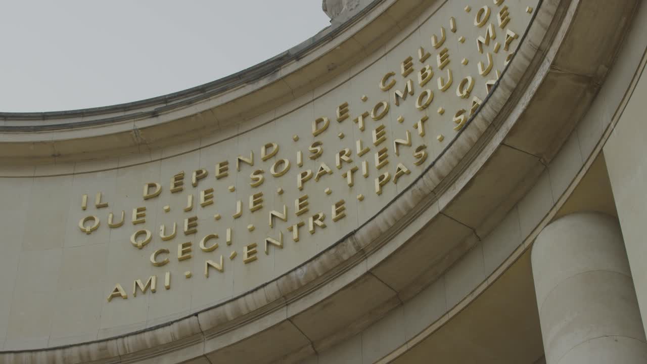 5K shot of French words mounted on an old building near the Eiffel Tower.
