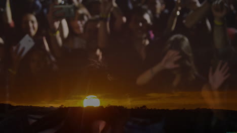 female singer singing into microphone on stage with fans, showing sunset horizon for music industry