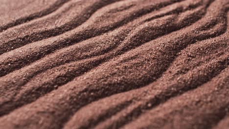 Video-of-close-up-of-brown-coloured-sand-with-pattern-and-copy-space-background