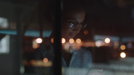close up beautiful business woman working late using tablet computer browsing research data statistics on screen brainstorming successful project deadline strategy looking out window planning ahead