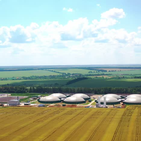 modern bio farm surrounded by green nature. innovative agriculture reservoirs for bio gas production on field in summer. aerial view