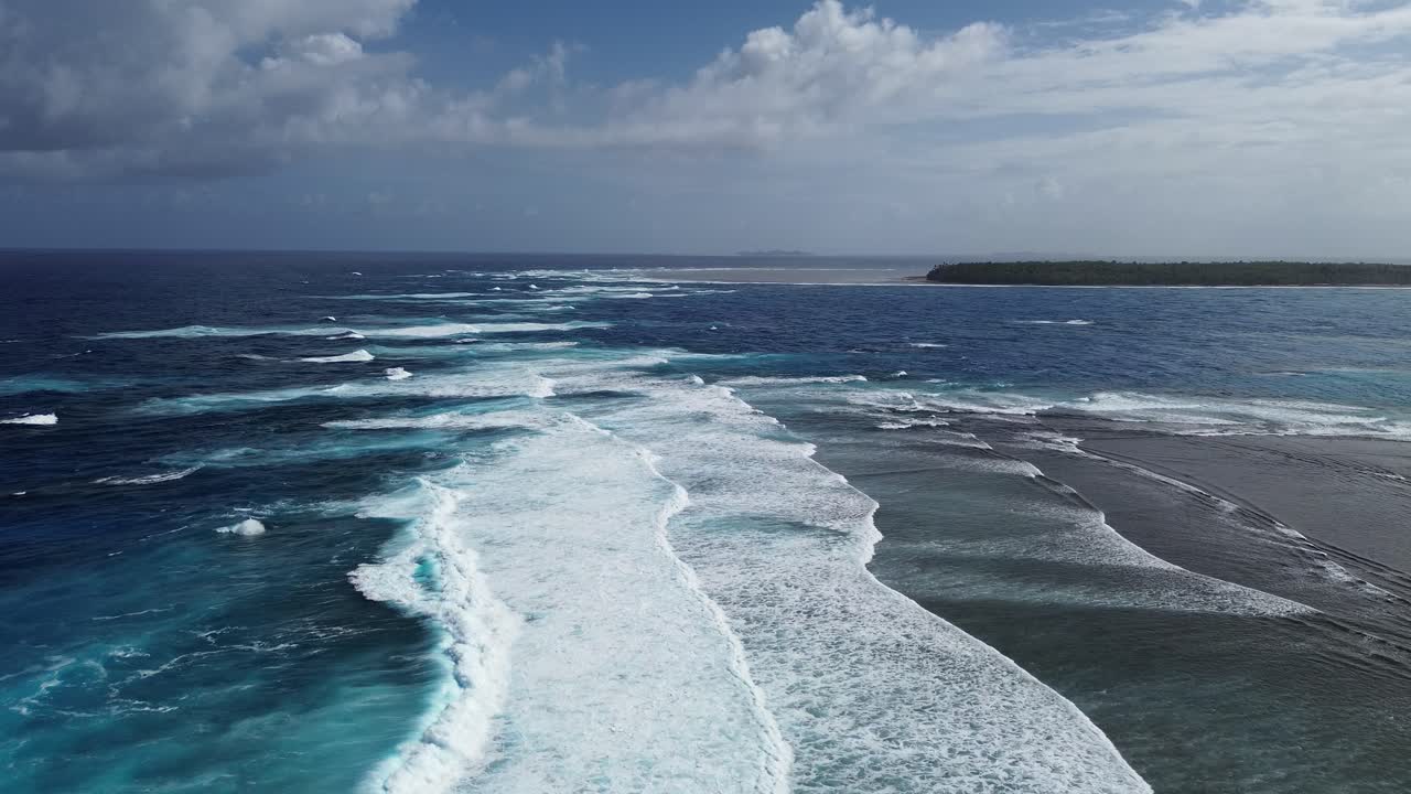 Low aerial view of beautiful surfing waves in Siargao Island, Philippines