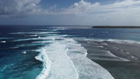 low aerial view of beautiful surfing waves in siargao island, philippines