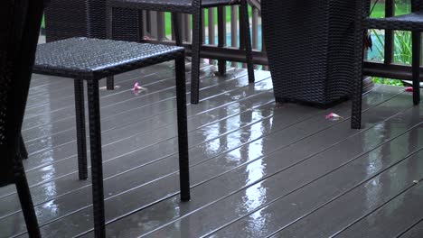 light pattering of rain onto a deck at the end of summer
