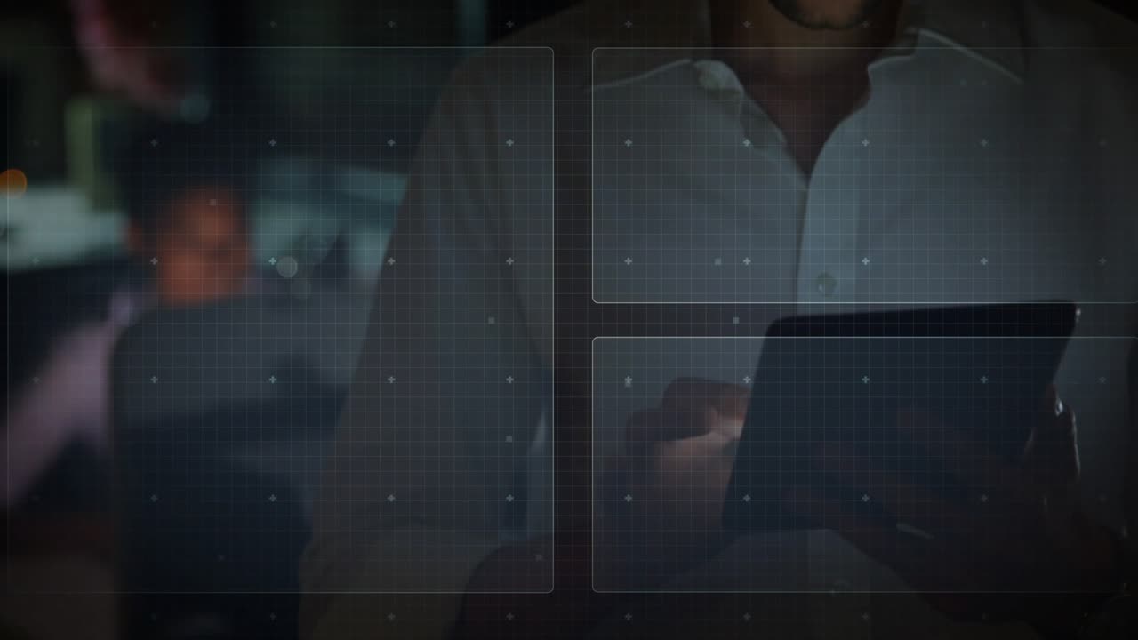 Tech analyst tapping tablet and scrolling in dim room activating radar globe and shifting chart