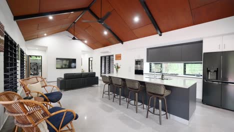 spacious tropical villa interior with an open-plan design, featuring high ceilings, modern furnishings, and natural lighting for an airy atmosphere