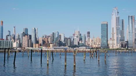 manhattan city skyline over hudson river, new york city, slow pan left