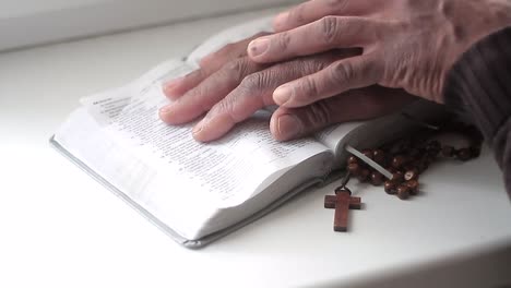 praying to god with hands together with bible and cross black man praying with black background stock video stock footage