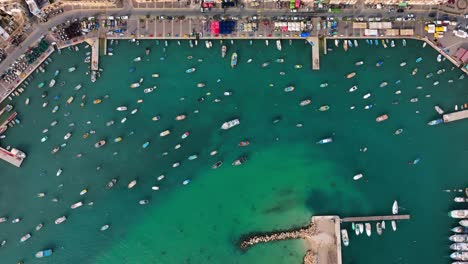 drone top down shot of fishing boat anchored in the bay