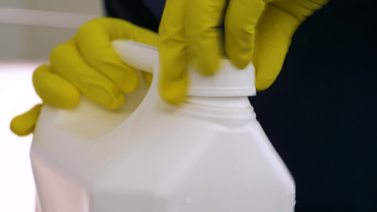 Closing Chemical Jerrican with Cleaning Latex Gloves, Close Up