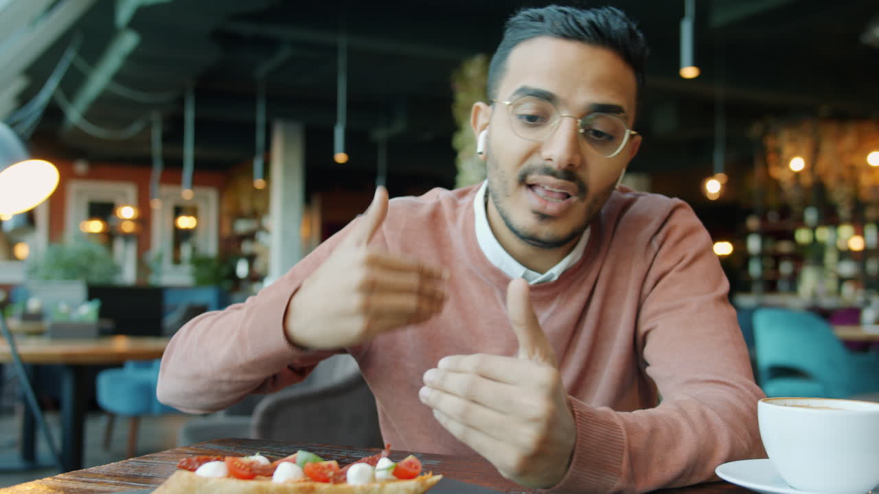 Businessman having a video call in a cafe