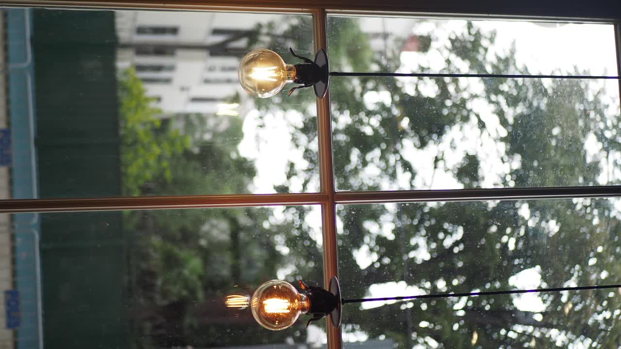 Light bulbs hanging in front of a window