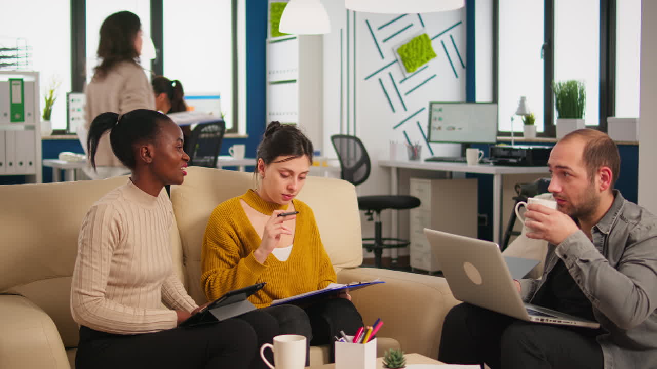 Woman executive instructing diverse employees in new modern company