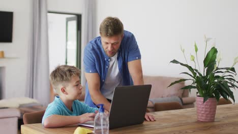 Caucasian-man-standing-and-helping-his-son