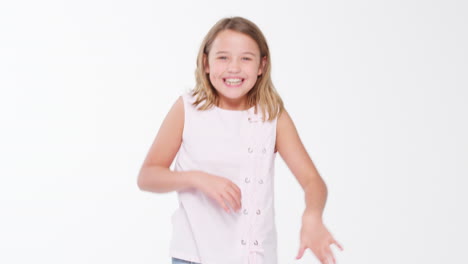 girl jumping and posing against white studio background