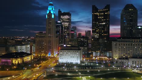 aerial view in front of a urban city center, lit up columbus - rising, drone shot