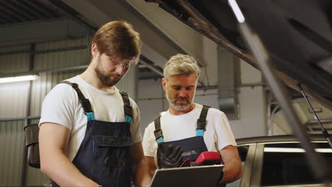 car repair technicians working on a vehicle