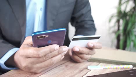 man using smartphone and credit card for online payment