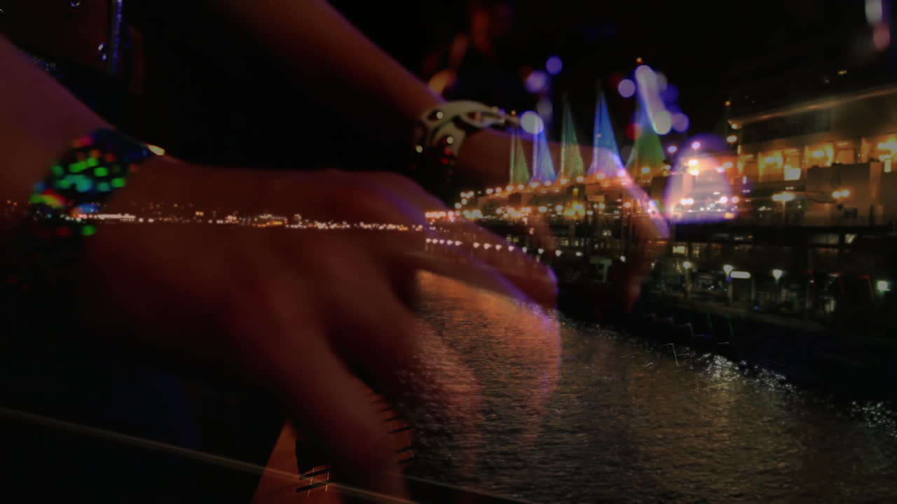 Male musician playing stringed instrument at urban waterfront night, with animated neon music waves