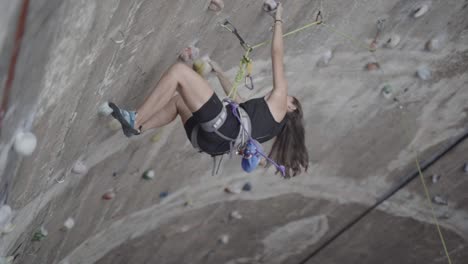 woman losing rock climb grip at la foixarda recreational center barcelona