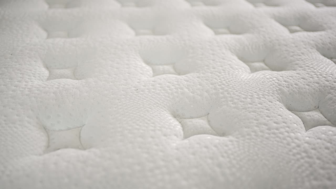 Zooming in on the unique texture of a mattress surface reveals its design and comfort features. Understanding this material can help improve your sleep experience