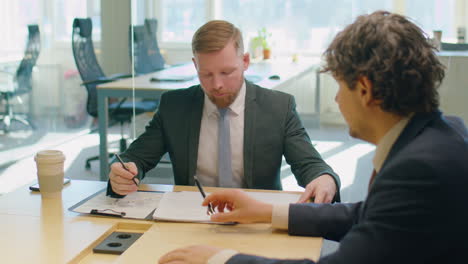 male colleagues discussing business report
