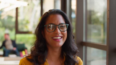 Portrait-Of-Mature-Businesswoman-Wearing-Glasses-Working-In-Office-At-Desk