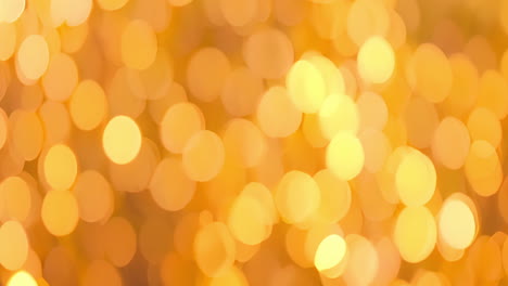 cinemagraph of yellow, orange and gold bokeh light spots moving slowly