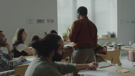 diverse students learning in a classroom with an african american teacher