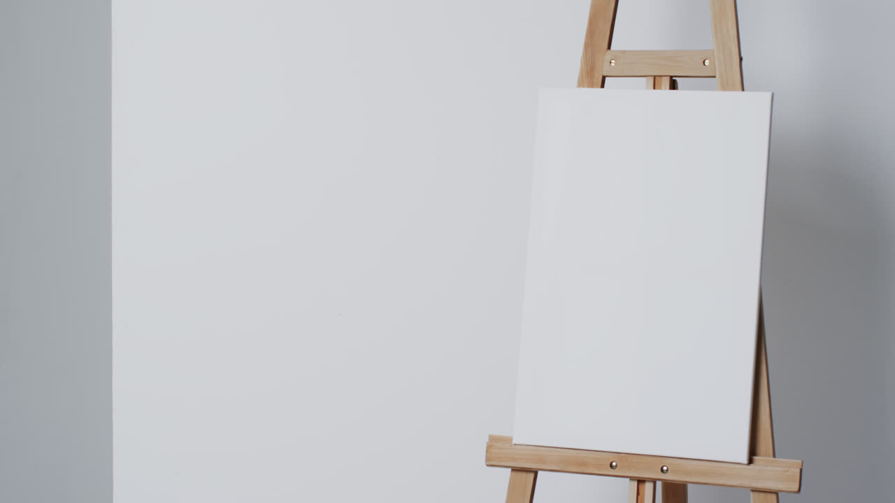 Video of white canvas sign on wooden easel with copy space on white background
