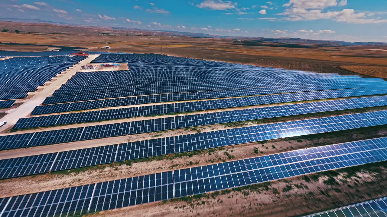 High-speed FPV drone flight over a sprawling solar farm, showcasing the vast potential of renewable energy