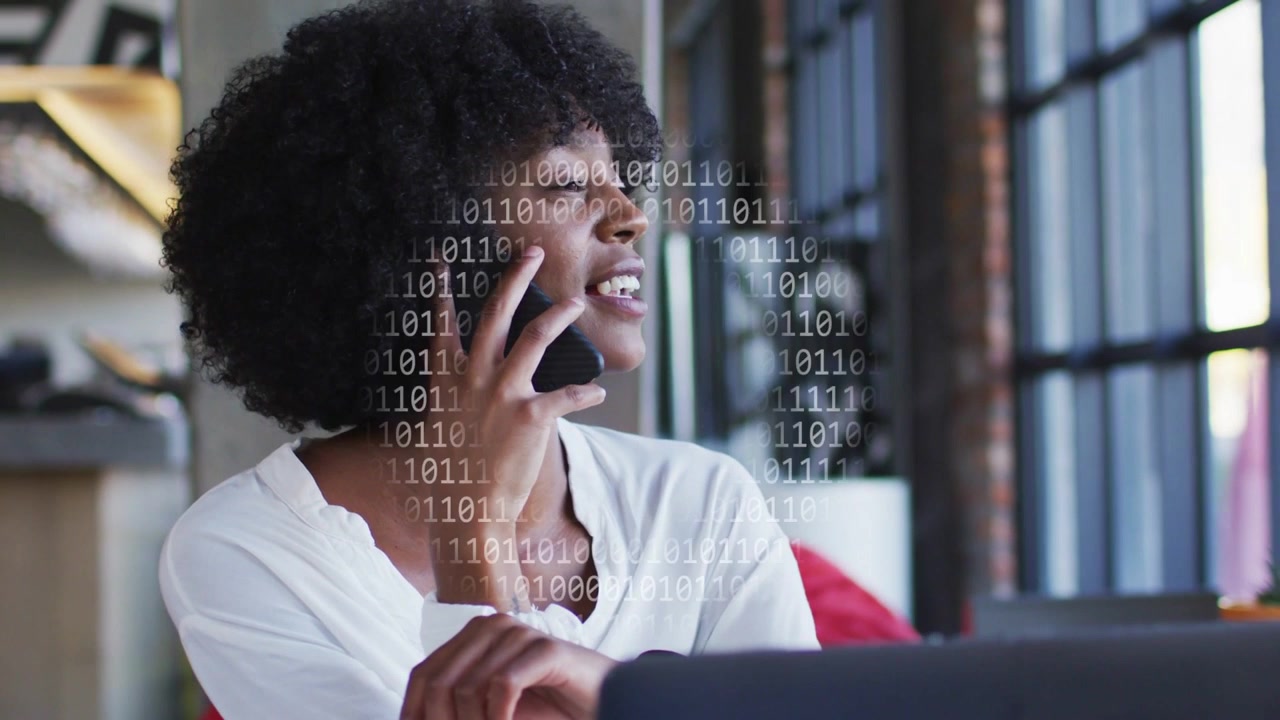 Woman on phone gesturing during call, binary overlay appearing, tapping screen, working remotely