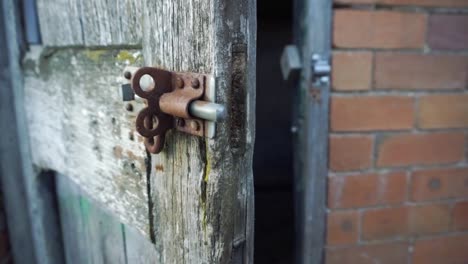 pan around rusted bolt and creaky old wooden door