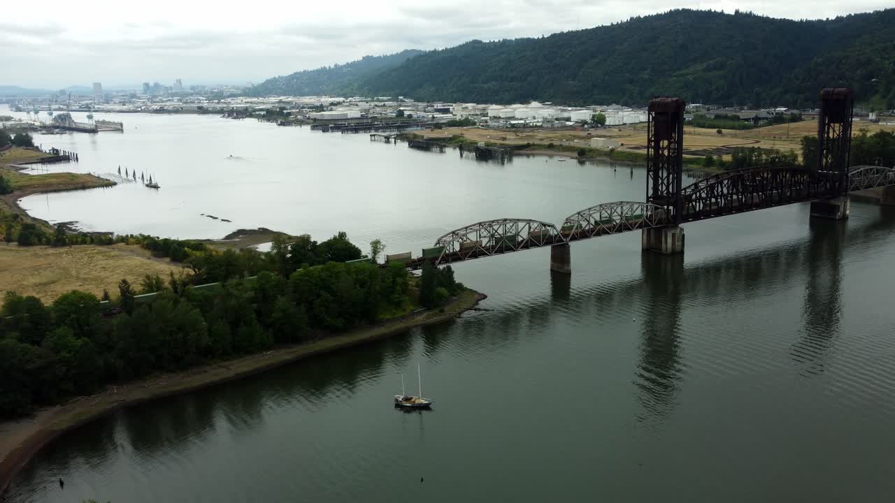 US, Oregon, Portland, St Johns, 2025-07-26 - Drone view of a freight train going across the Train Bridge