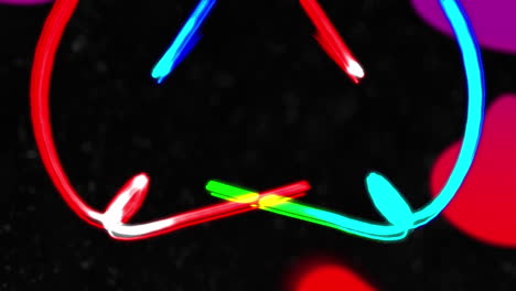 animation of blue, green and red light trails with red and purple globules on black background