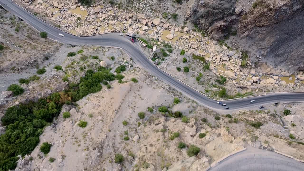 Drone Aerial of Kabul Afghanistan, dangerous winding mountain roads on cliffs in arid Hindu Kush mountains bordering Pakistan