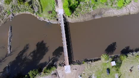 Aerial-video-going-down-the-bridge-over-the-river