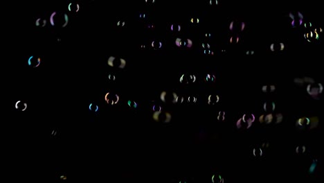 small round transparent soap bubbles fly very fast black background small round transparent soap bubbles fly very fast in a chaotic manner and create the impression of joy black background