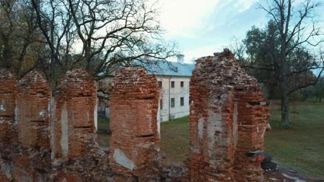 Aerial-View-of-the-Ruins-of-an-Ancient-Manor-in-Golden-Autumn