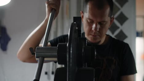 man working on metal press machine in workshop