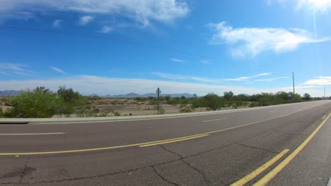 pov following a white van on highway through desert near quartzite arizona