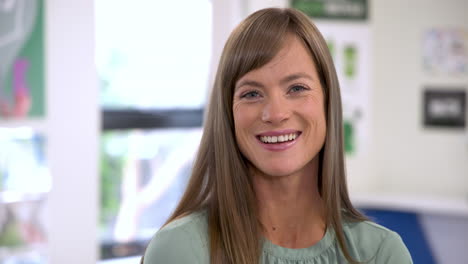 smiling woman in classroom, feeling confident and engaged in school environment
