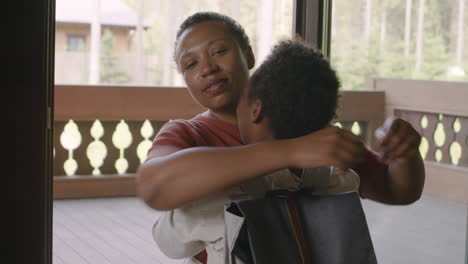 loving mother hugging her son at home