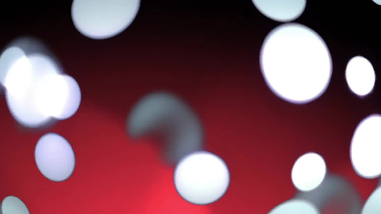 Animation of glowing light spots moving over red and black background