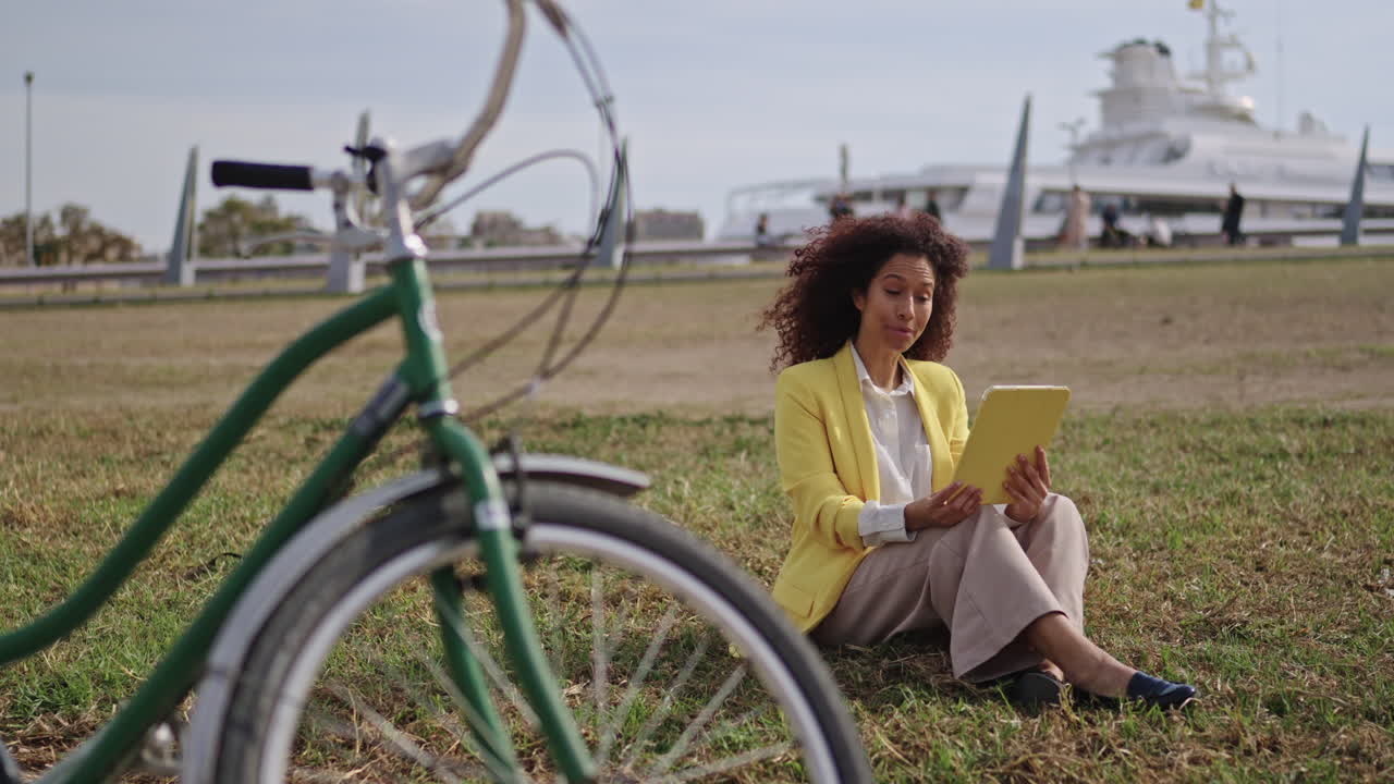 Woman with Tablet in Urban Park
