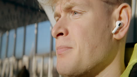 man wearing earbuds outdoors