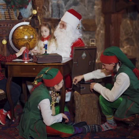 santa looking at globe with child
