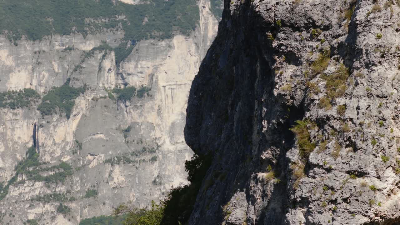 Rugged Dolomites cliff in daylight, showcasing nature's raw beauty