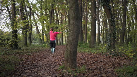woman stretching on a forest path