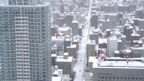 aerial view of snowed in street in snowed in city